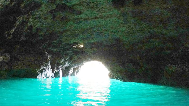 A sea cave at Ponta da Piedade, the water lit green from below